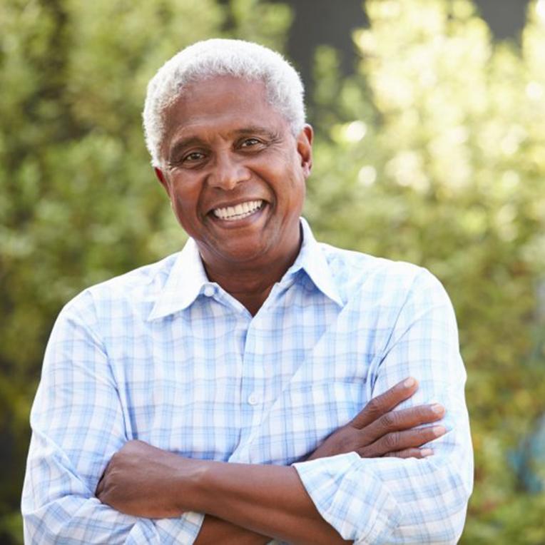 Man with flawless smile standing outdoors
