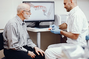 Patient and dentist talking during tooth replacement consultation
