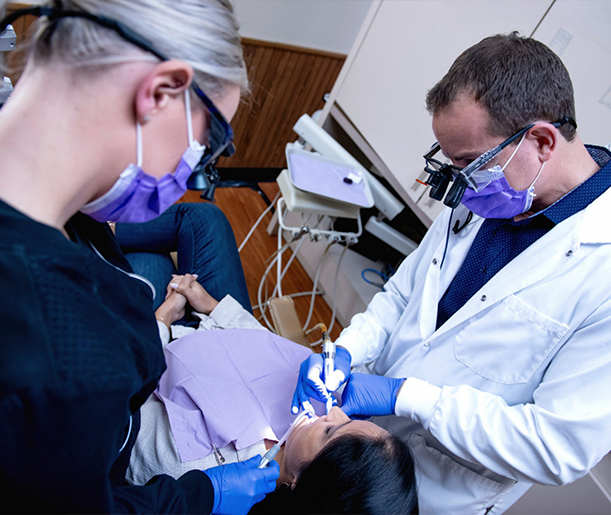 Doctor Young and dental assistant treating a dental patient
