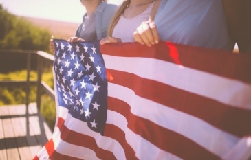 Group of people holding an American flag
