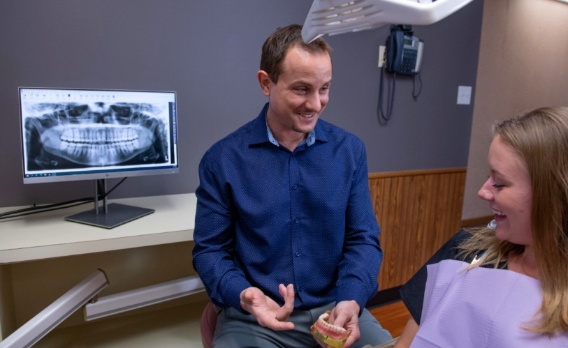 Doctor Young showing dental x rays to a patient