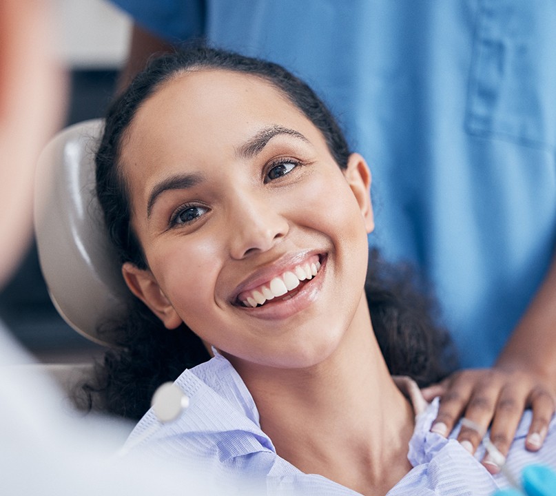 Happy patient smiling at her dentist