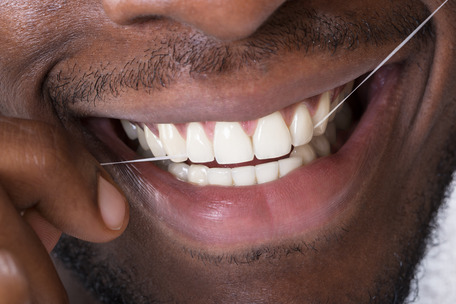 person flossing teeth