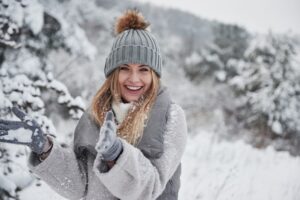 Smiling woman enjoying snowy weather