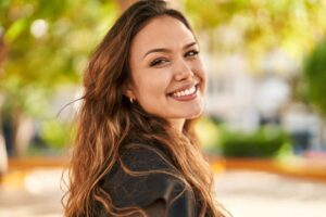 Confident woman with beautiful teeth looking over her shoulder 