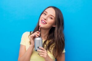 Woman sipping soda through a straw